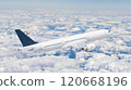 White passenger airplane is flying high above white clouds on a beautiful blue sky 120668196