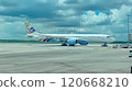 Large passenger airliner is taxiing on the runway, preparing for takeoff or after landing, under a cloudy sky 120668210