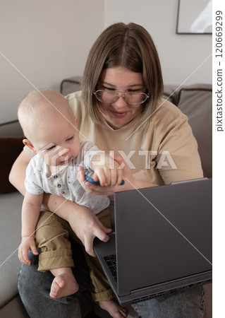 A parent balancing remote work responsibilities while caring for their baby during this time A parent balancing remote work responsibilities while caring for their baby during this time 120669299