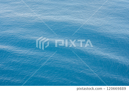 Blue ocean water texture background with gentle waves and ripples. Calm sea surface with light reflections. background wallpaper, Serene and peaceful marine scenery Blue ocean water texture background with gentle waves and ripples. Calm sea surface with light reflections. background wallpaper, Serene and peaceful marine scenery 120669889