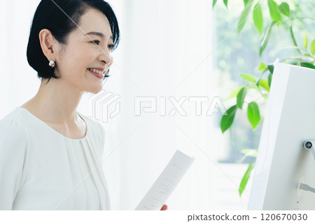 Businesswoman looking at documents Businesswoman looking at documents 120670030