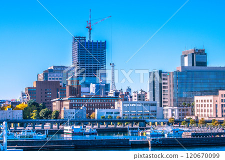 Yokohama cityscape in Japan. A city with a pedestrian bridge. View of the Kanagawa Prefectural Office, sightseeing boats, and the redevelopment project in front of Kannai Station, November 28th. 120670099