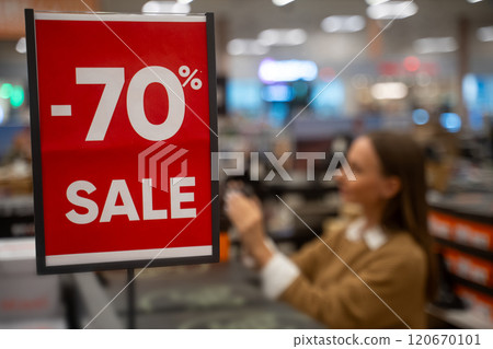 Massive discount sale at retail store with 70 percent off on various items capturing shopper excitement 120670101
