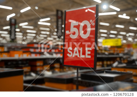 Shopping for great deals at a store during a 50 percent discount event in a bustling retail environment Shopping for great deals at a store during a 50 percent discount event in a bustling retail environment 120670128