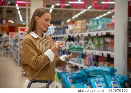 Scanning wet wipes with a smartphone in a grocery store 120670162