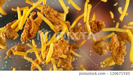 French Fries with Chicken Pieces Flying up in the Air. 120671593