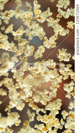 Freeze motion of flying tasty popcorn, close-up Freeze motion of flying tasty popcorn, close-up 120672064