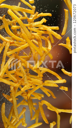 Freeze motion of flying french fries on gradient background Freeze motion of flying french fries on gradient background 120672073