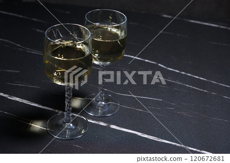 Image of a toast with two wine glasses filled with white wine 120672681