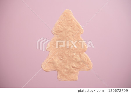 Sparkly beige cream shaped like a Christmas tree on pink background. Holiday makeup and body care 120672799