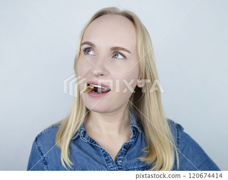 Prevention of thyroid diseases. Woman holds brazil nuts, rich in selenium, good for the thyroid gland 120674414