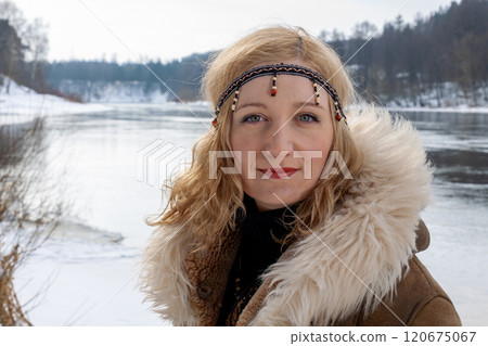 A young woman with blonde hair dressed in a warm fur-lined leather coat A young woman with blonde hair dressed in a warm fur-lined leather coat 120675067