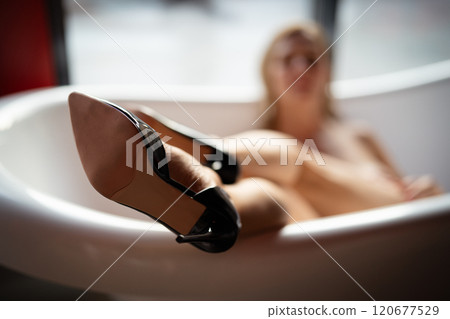 Woman feet high heels shoes in bathrobe at home, closeup 120677529