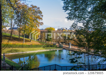 Amazing autumn view  in park of Saint Cloud with a old nude statue of a Roman warrior   and Fantastic orange color in frame of shot 120679005