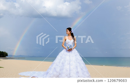 Bride with bouquet at the beach 120679083