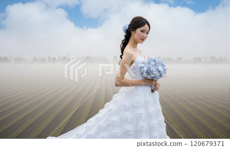 Pre-bridal photo shoot: Bride holding a bouquet in the grassland 120679371