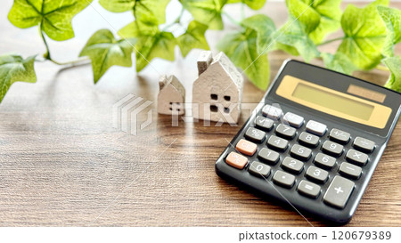 Two household items and a calculator_Brown board background 120679389