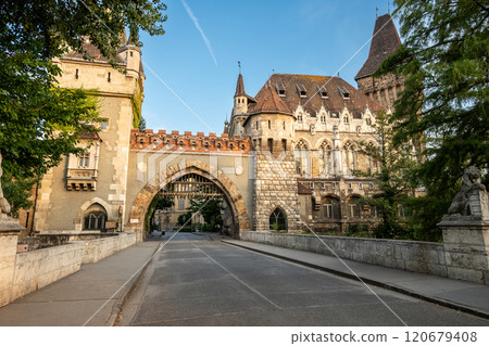 Budapest, Hungary. August 27, 2022. Shot walking towards the Gatehouse Tower entrance, warm late afternoon light illuminates the facade. We cross people, beautiful summer day. Travel destinations. 120679408