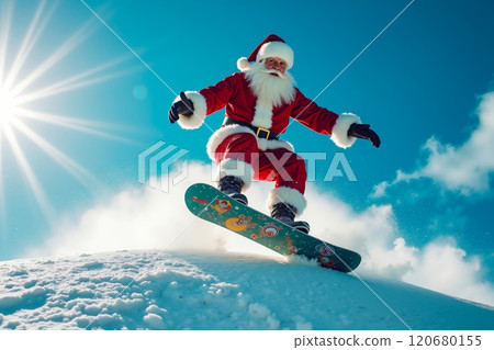 A man dressed as Santa Claus riding a snowboard on top of a snow covered hill 120680155