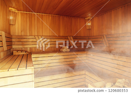 Interior of Finnish sauna, classic wooden sauna with hot steam. Russian bathroom. Relax in hot sauna with steam. Wooden interior baths, wooden benches and loungers accessories for sauna, spa complex Interior of Finnish sauna, classic wooden sauna with hot steam. Russian bathroom. Relax in hot sauna with steam. Wooden interior baths, wooden benches and loungers accessories for sauna, spa complex 120680353