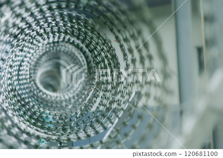 Intricate Spiral of Razor Wire with Geometric Patterns. Intricate Spiral of Razor Wire with Geometric Patterns. 120681100