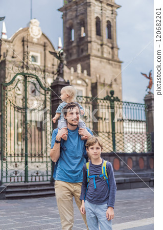 Father and son tourists in front of Catedral de Puebla, Mexico. Travel, cultural heritage, and historic architecture exploration concept 120682201