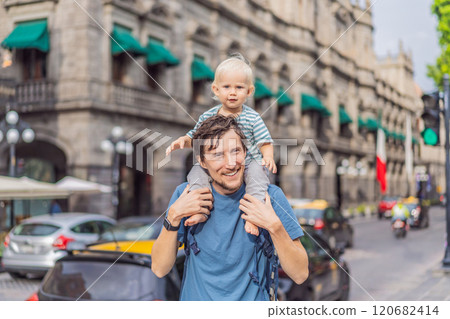 Father tourist with his toddler son walking through the colorful colonial streets of Puebla, Mexico. Travel, cultural exploration, and vibrant architecture concept 120682414