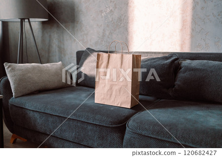 Shopping bag with boxes and shoes on sofa in room. Online business shopping concept. Shopping bag with boxes and shoes on sofa in room. Online business shopping concept. 120682427