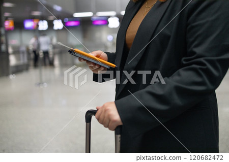 Portrait of positive cheerful traveler woman hold ticket ready enjoy voyage tour passenger walk in airport terminal to boarding gate. Attractive beautiful female tourist excited to go travel abroad by 120682472