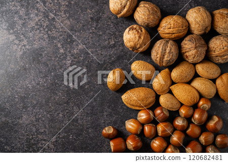 Mix of nuts on dark background. Almonds, hazelnuts, walnuts. Top view.  120682481