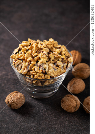 Walnuts in a glass bowl, dark background 120682492
