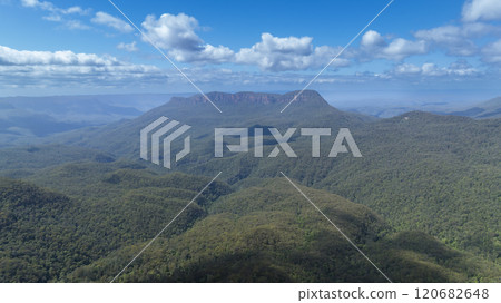 Large rock formations along a valley ridgeline 120682648