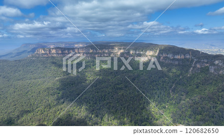 Large rock formations along a valley ridgeline 120682650