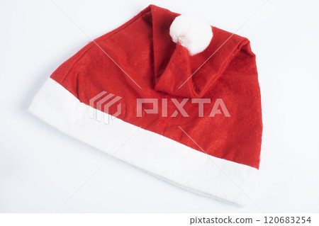 Festive red Santa hat with white fur trim on a white background, Top view 120683254