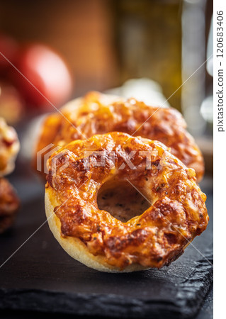 Mini pizza bagels on cutting board on black table. 120683406