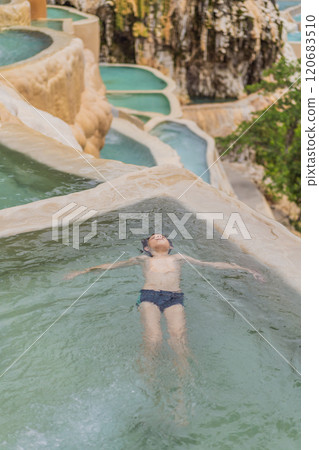 Teenage boy bathing in the hot springs of Grutas Tolantongo, Mexico. Family adventure, relaxation, and natural wellness concept Teenage boy bathing in the hot springs of Grutas Tolantongo, Mexico. Family adventure, relaxation, and natural wellness concept 120683510