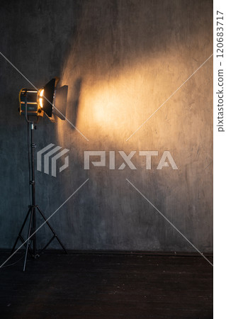 Lighting fixture shines of a dark photo studio Lighting fixture shines of a dark photo studio 120683717