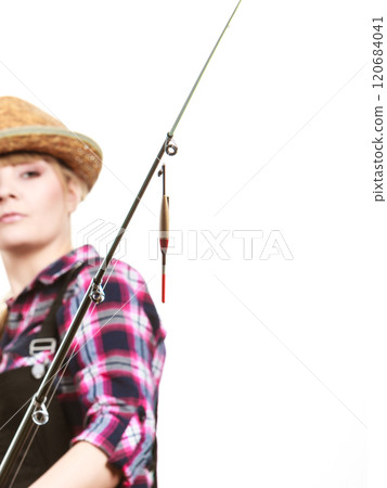 Focused woman looking at fishing rod float 120684041