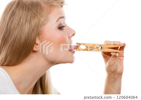 Blonde woman having tongue in clothespin Blonde woman having tongue in clothespin 120684064
