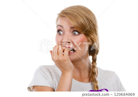 Scared, stressed woman biting her nails 120684069