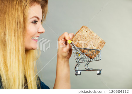 Woman holding shopping cart with bread 120684112