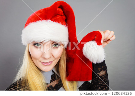 Happy woman wearing Santa Claus helper hat 120684126