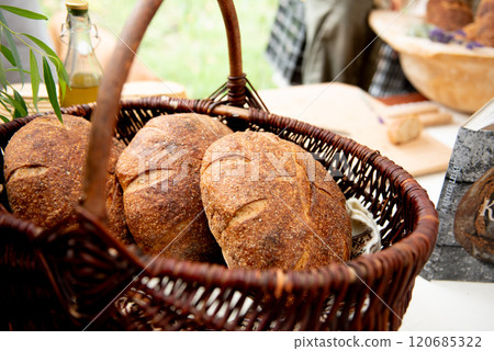 three sourdough whole grain loaf of bread in the basket 120685322