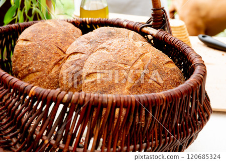 three sourdough whole grain loaf of bread in the basket 120685324