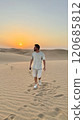 A serene man in the vast desert, a peaceful Sunset 120685812