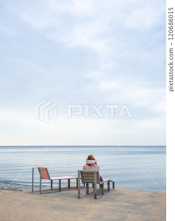 Benches for lying by the sea. Sun loungers in the park against the background of the sea. Benches in the park in the southern resort. Benches for lying by the sea. Sun loungers in the park against the background of the sea. Benches in the park in the southern resort. 120686015