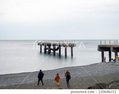 People are walking along the pier. Cold season at the resort. Not a season. 120686251