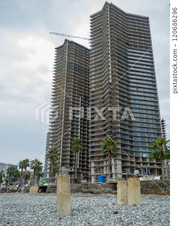 Reinforced concrete pile sticking out of the ground. Construction on the beach. Abandoned. Armature at sea. Destroyed building. 120686296
