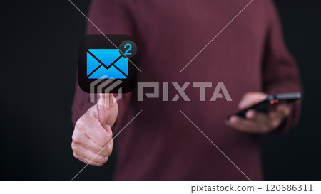 A person interacts with a virtual email notification showing two new messages. The concept illustrates communication, technology, and digital engagement using mobile devices. A person interacts with a virtual email notification showing two new messages. The concept illustrates communication, technology, and digital engagement using mobile devices. 120686311