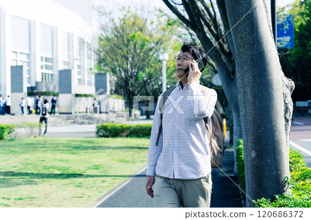 Dollar man talking on smartphone outdoors 120686372